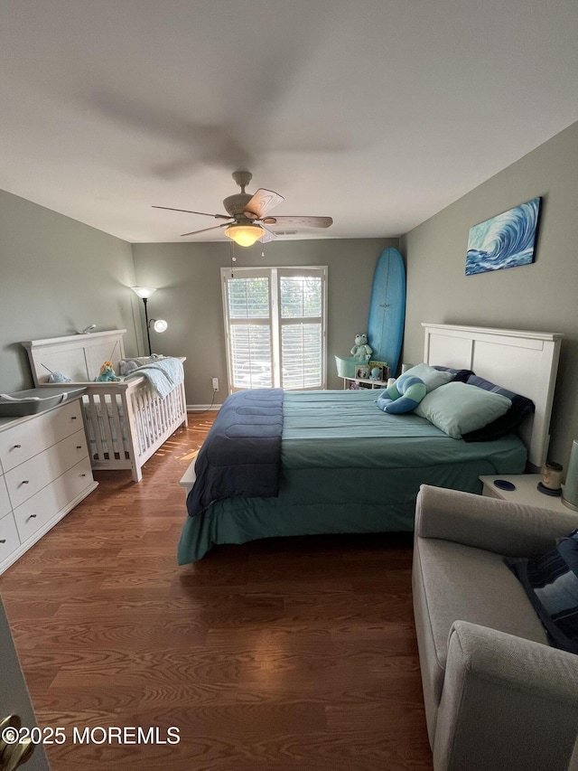 bedroom with ceiling fan and dark hardwood / wood-style flooring