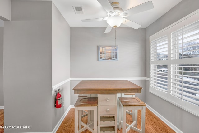 dining area with ceiling fan and light hardwood / wood-style flooring