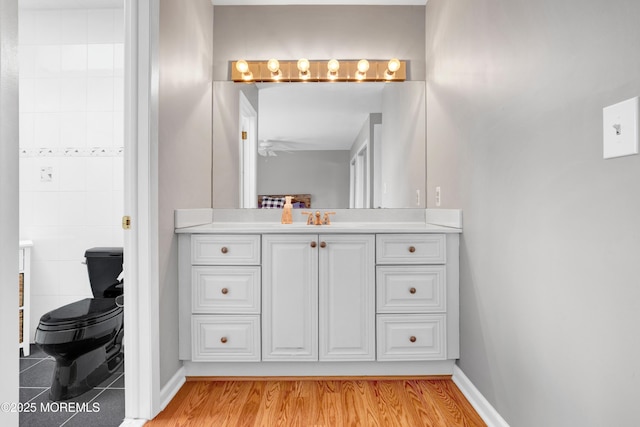 bathroom featuring hardwood / wood-style flooring, toilet, and vanity