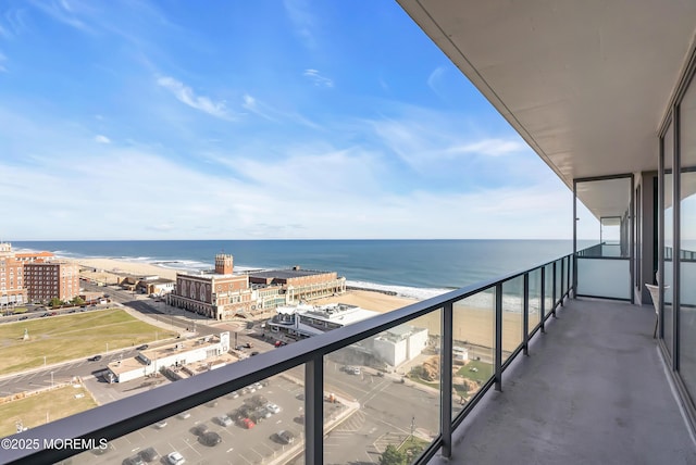 balcony with a water view and a beach view