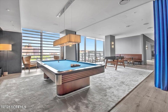 game room with a wall of windows, wood-type flooring, and pool table