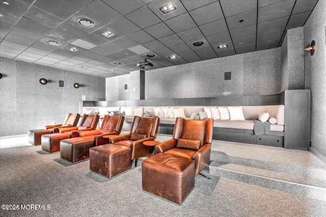 cinema room featuring a paneled ceiling and carpet floors