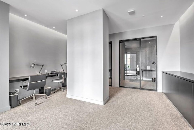 hallway featuring light colored carpet