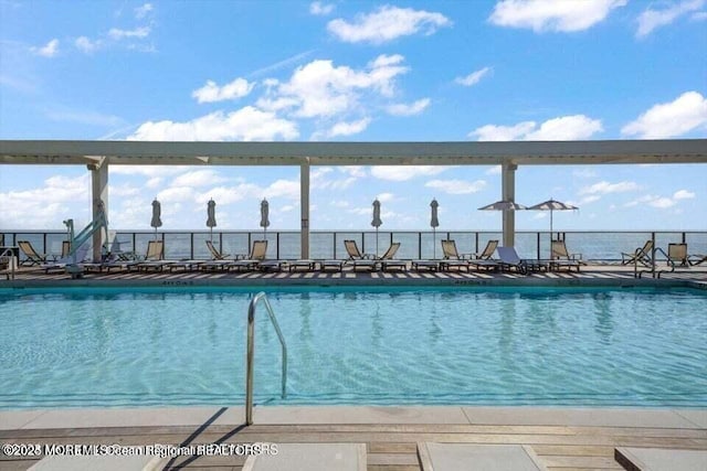 view of pool featuring a water view