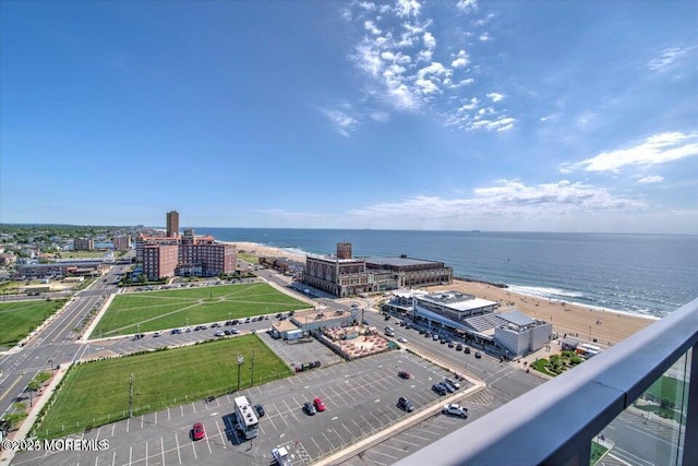 birds eye view of property with a water view and a beach view