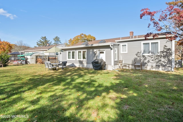 rear view of house with a lawn