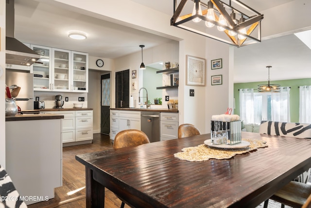 dining room featuring dark wood-type flooring and sink