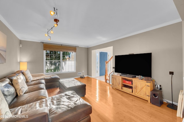 living room with ornamental molding and wood-type flooring