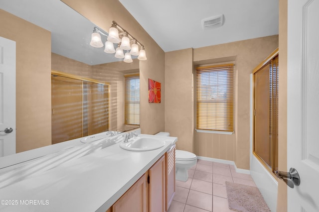 full bathroom with toilet, tile patterned flooring, bath / shower combo with glass door, and vanity