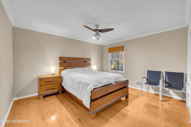 bedroom featuring ceiling fan, hardwood / wood-style flooring, and ornamental molding