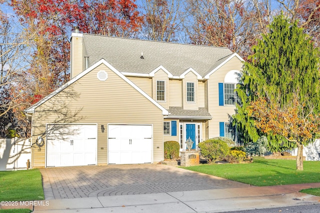 view of front property with a front lawn and a garage