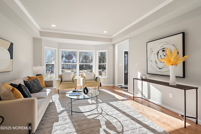 living room featuring light hardwood / wood-style flooring and crown molding