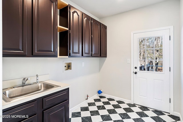 laundry room featuring sink, gas dryer hookup, hookup for a washing machine, and cabinets