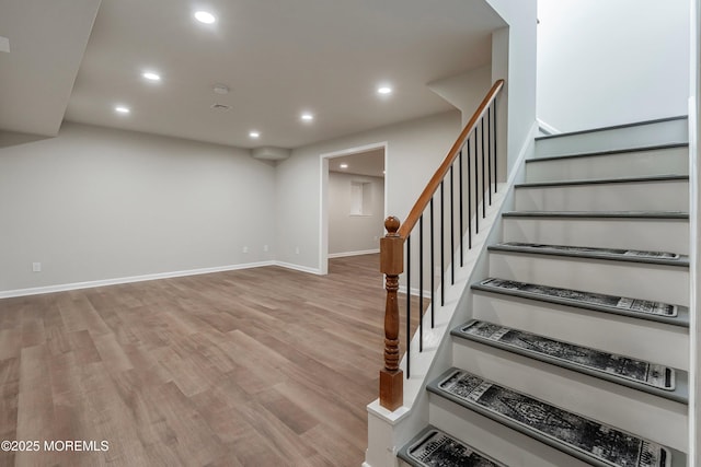 staircase featuring wood-type flooring