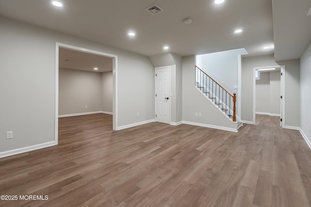 basement with hardwood / wood-style floors