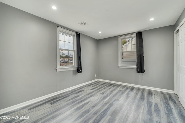 empty room with wood-type flooring