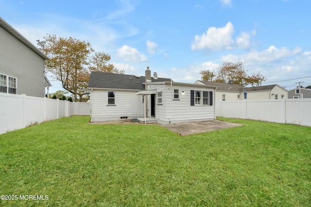 rear view of property with a patio area and a yard