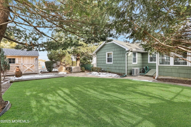 view of yard featuring central AC and a storage shed