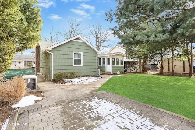 rear view of property featuring a lawn