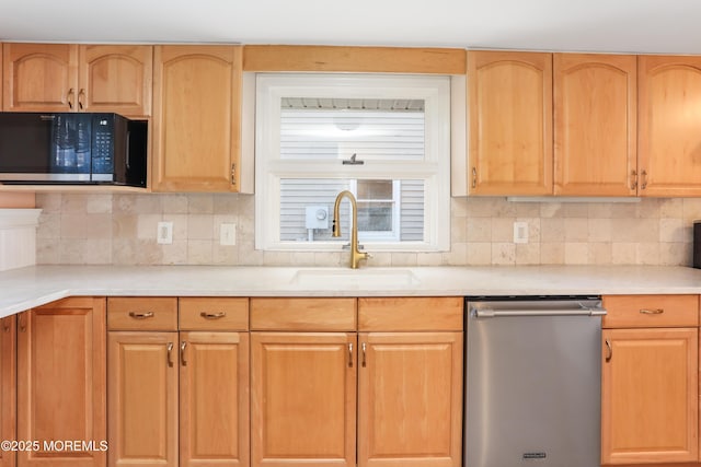 kitchen featuring sink, backsplash, and dishwasher