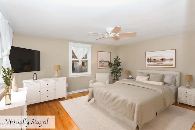 bedroom with ceiling fan and light hardwood / wood-style floors