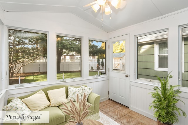 sunroom / solarium featuring ceiling fan and vaulted ceiling