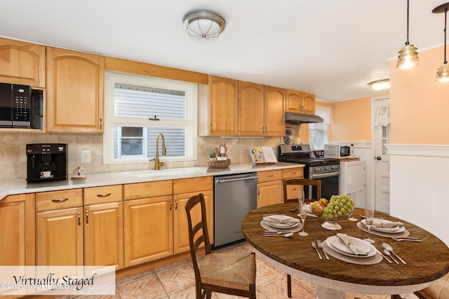 kitchen with decorative light fixtures, appliances with stainless steel finishes, backsplash, and a wealth of natural light