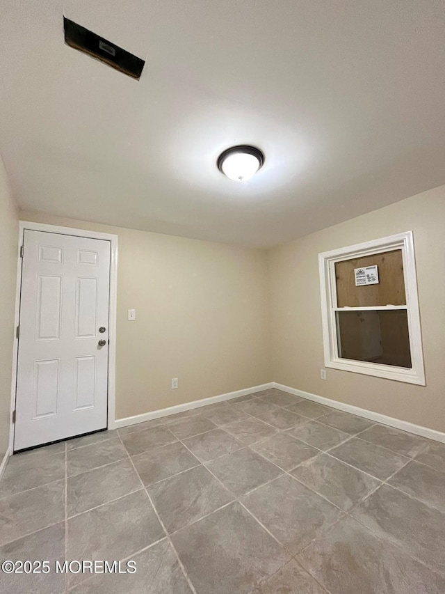 unfurnished room with light tile patterned floors