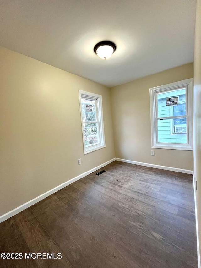 empty room featuring dark wood-type flooring