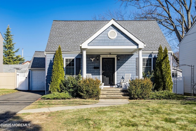 bungalow-style home featuring a garage and a front yard