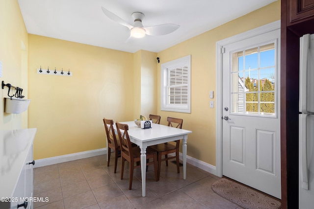 dining space with ceiling fan and light tile patterned floors