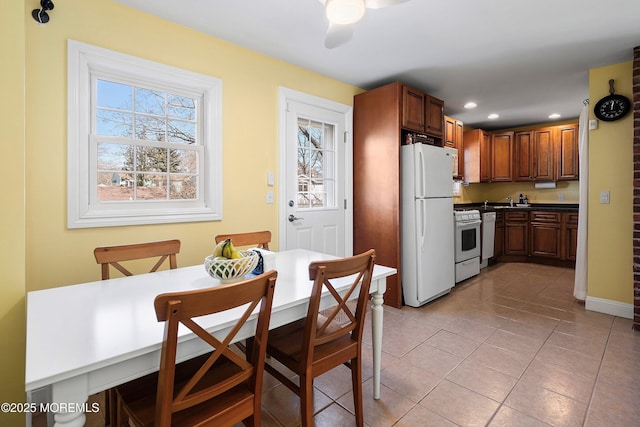 kitchen featuring white appliances, ceiling fan, and light tile patterned floors