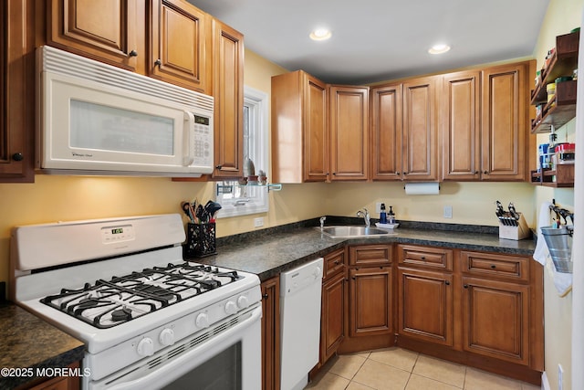 kitchen featuring sink, white appliances, and light tile patterned floors