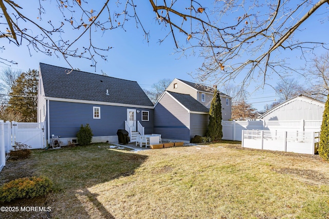 rear view of property featuring a yard