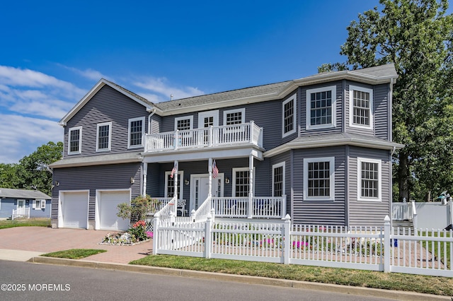 view of front facade with covered porch, a balcony, and a garage