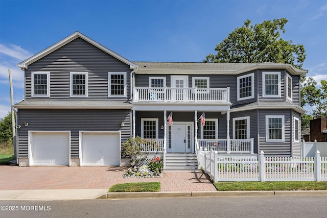 view of front of property with a balcony, covered porch, and a garage