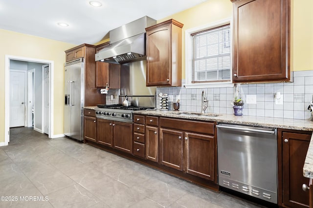 kitchen with ventilation hood, sink, decorative backsplash, appliances with stainless steel finishes, and light stone counters