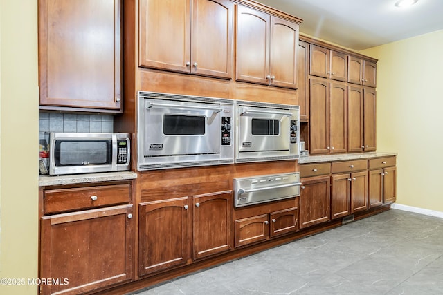 kitchen featuring decorative backsplash and stainless steel microwave