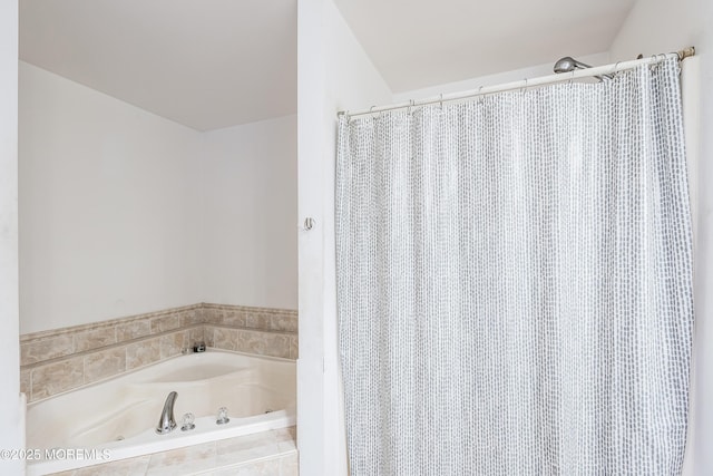 bathroom featuring tiled tub