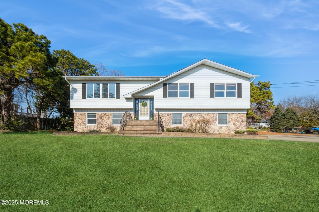 raised ranch featuring a front yard