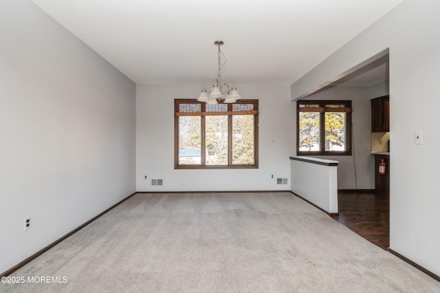 interior space with light colored carpet and a notable chandelier