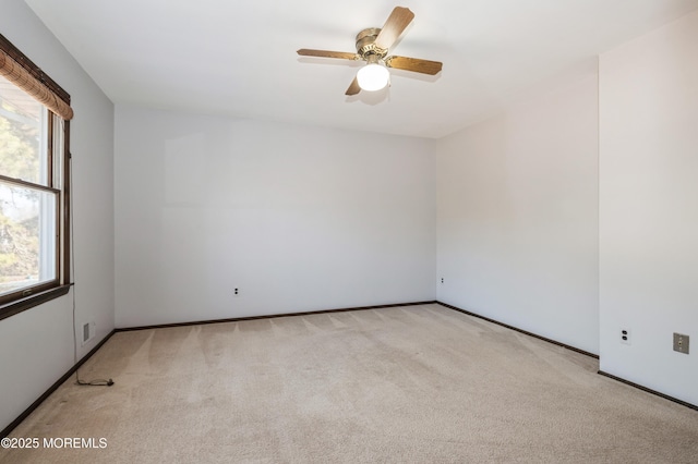 carpeted spare room with ceiling fan