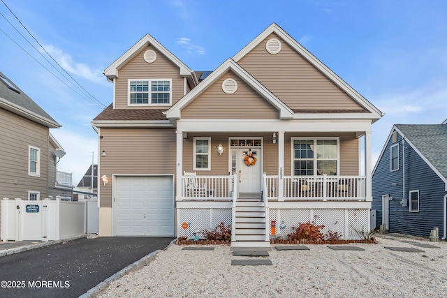 view of front of home featuring covered porch and a garage