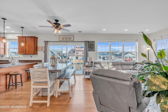 dining room featuring light hardwood / wood-style floors and ceiling fan