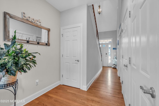 hallway with light hardwood / wood-style floors