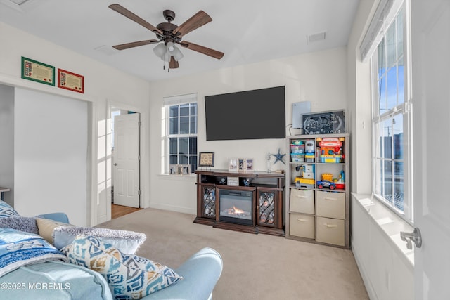 carpeted living room with ceiling fan