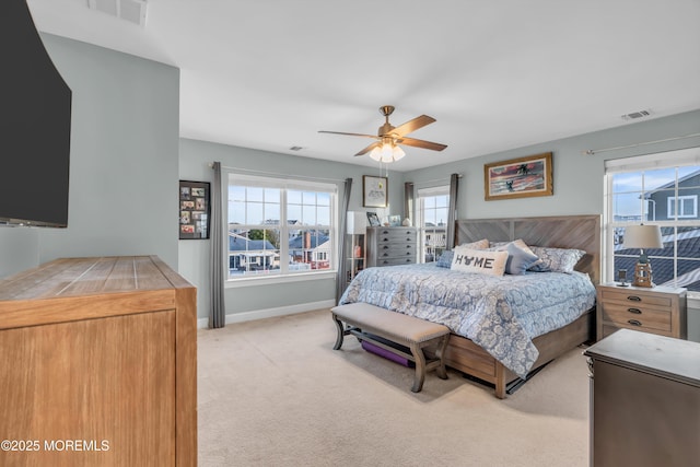 bedroom featuring ceiling fan and light carpet