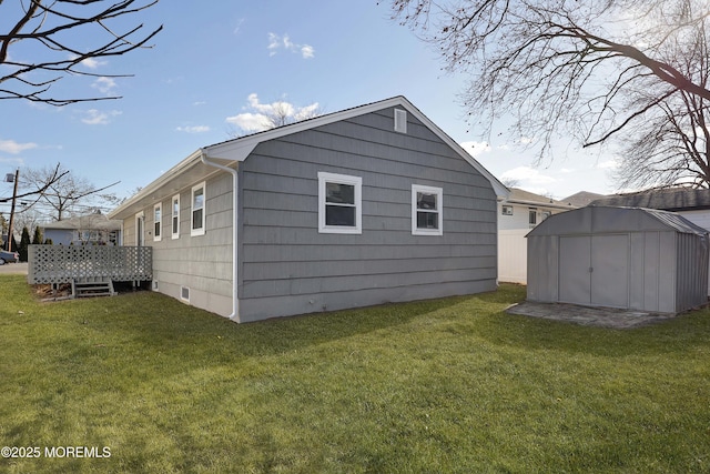 exterior space featuring a storage shed, a wooden deck, and a yard