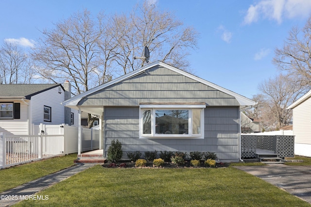 bungalow-style home with a front yard