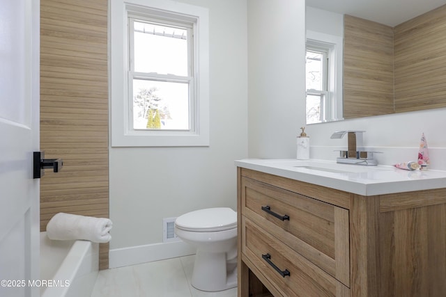 bathroom with toilet, tile patterned floors, and vanity